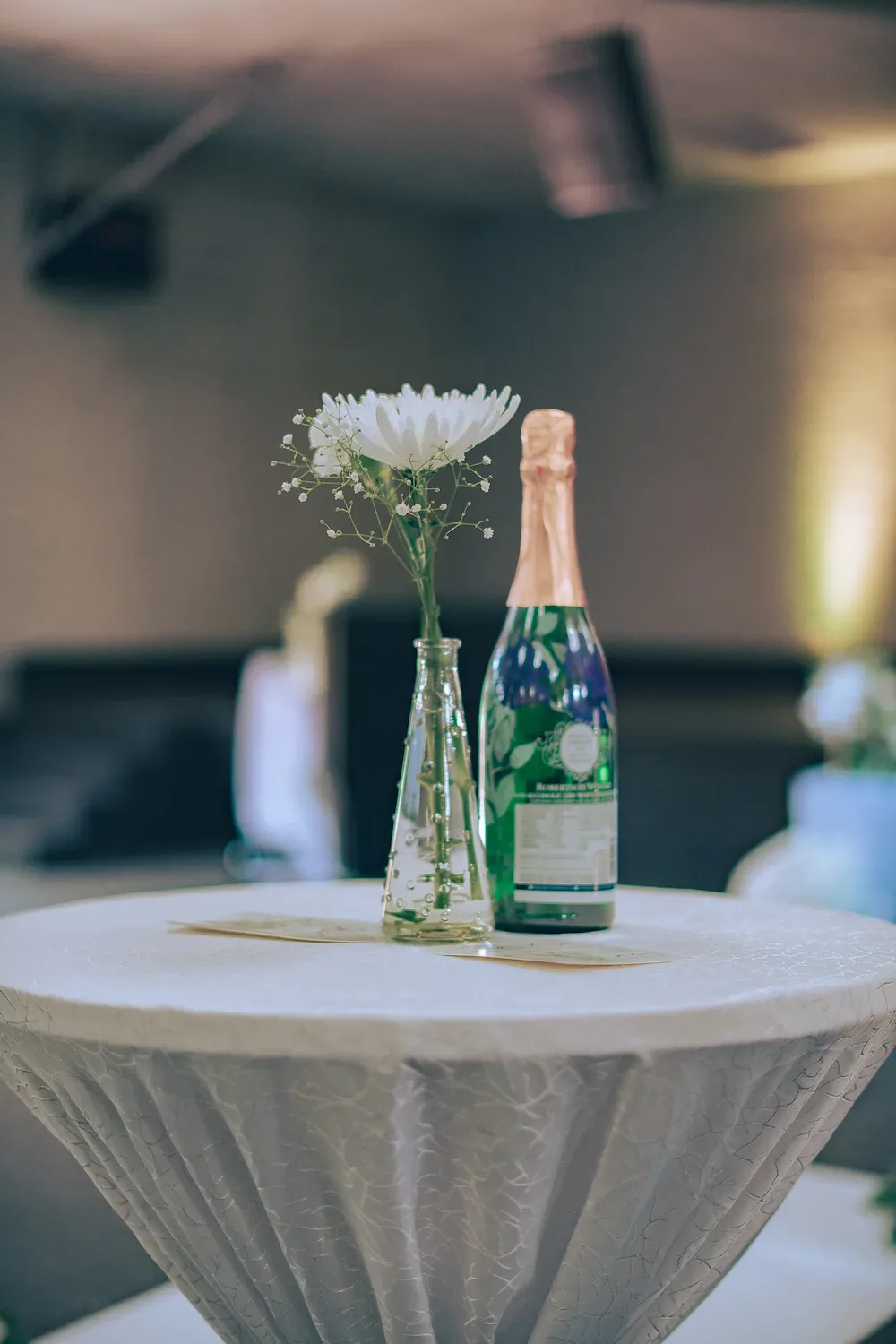 White floral arrangement displayed on a wedding reception table