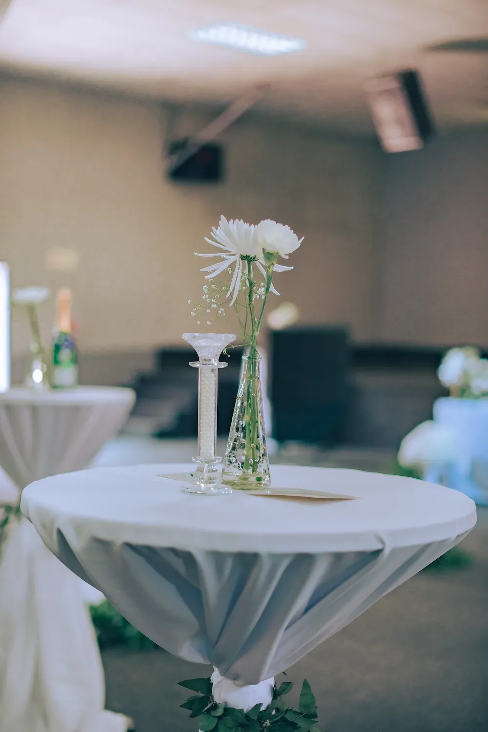 Champagne bottle and glass arranged on a styled wedding table